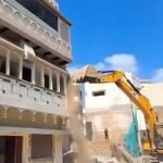 bulldozer on olympian mohammad shahid house in varanasi road widening action