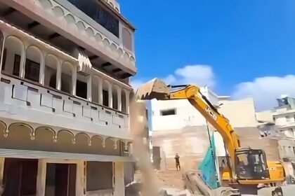 bulldozer on olympian mohammad shahid house in varanasi road widening action
